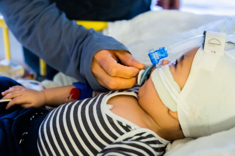 A father cares for his 8-and-a-half-month-old son, who is in the intensive care unit of the pediatric clinic at St. Joseph Hospital in Berlin with a respiratory infection and is receiving non-invasive ventilation (CPAP ventilation).