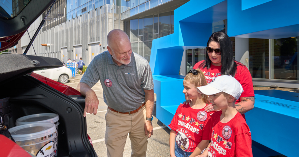 Chevrolet regional director Paul Beckett presents the Tinsley family with a Chevy Trax.