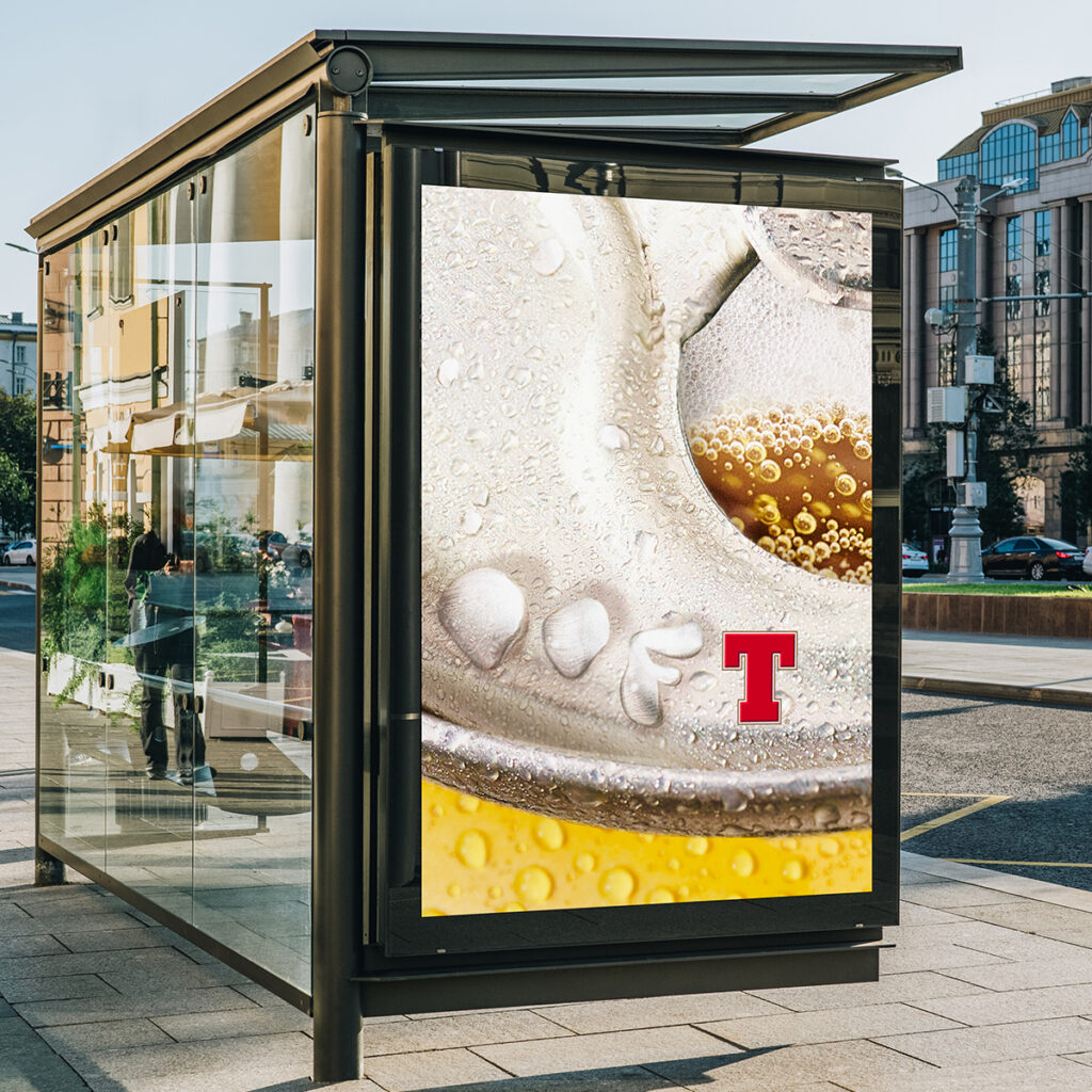 a bus billboard with a glass of beer