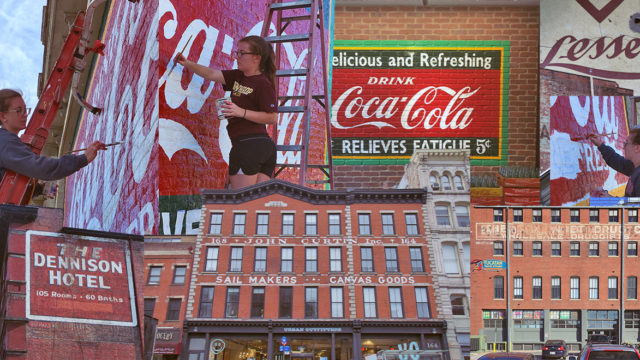 Ghost signs were once brightly painted advertisements, but after years of hiding and neglect, they're disappearing. Artists and designers don't all agree about restoring them.