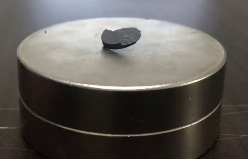 Pellet of LK-99 being repelled by a magnet.