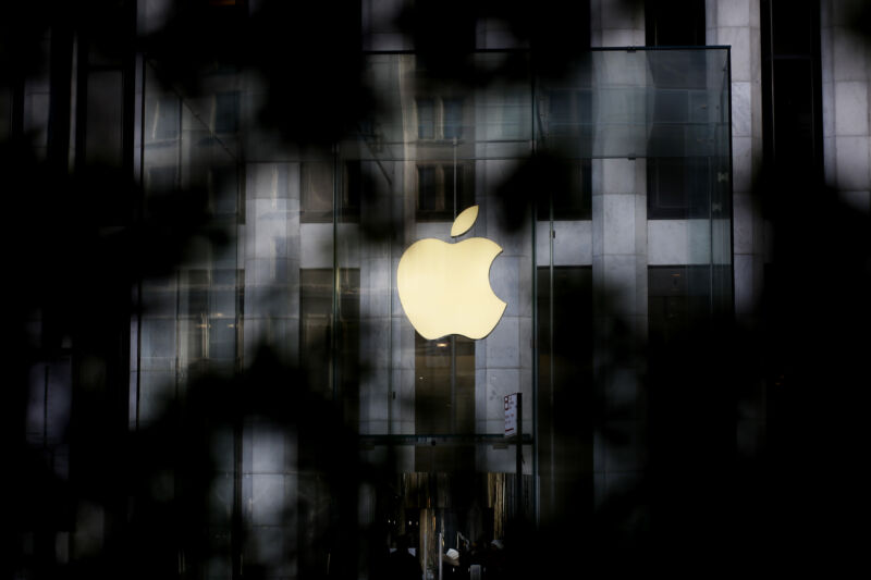 Apple logo obscured by foliage