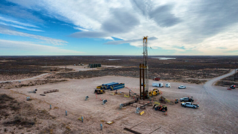 Image of a vertical metal frame surrounded by equipment.