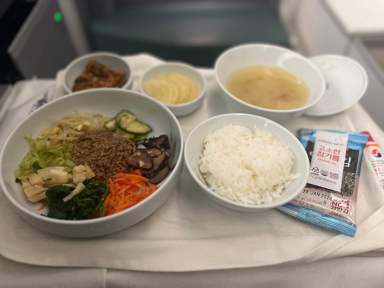 Bibimbap, a traditional korean dish, on a fold-down tray.