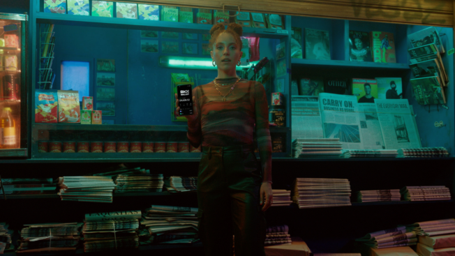 a woman standing in front of a newsstand