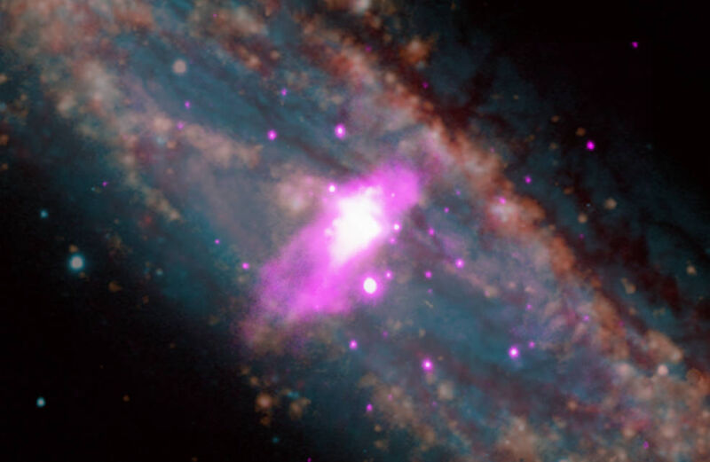 Image of a galaxy with a purple blob superimposed on its center.