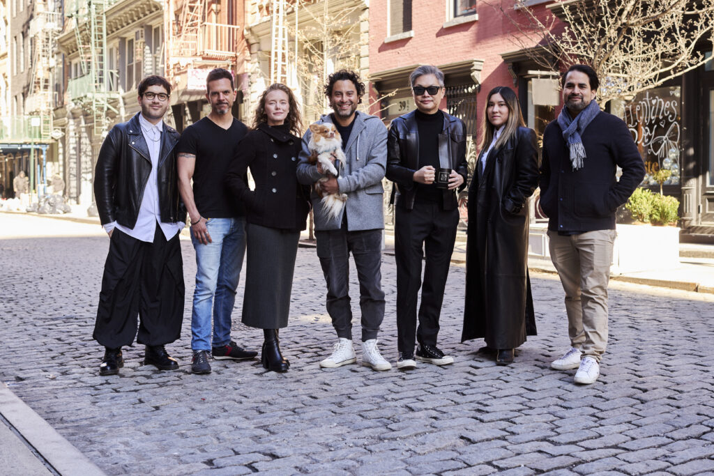 a group of people standing in the middle of a cobblestone street 