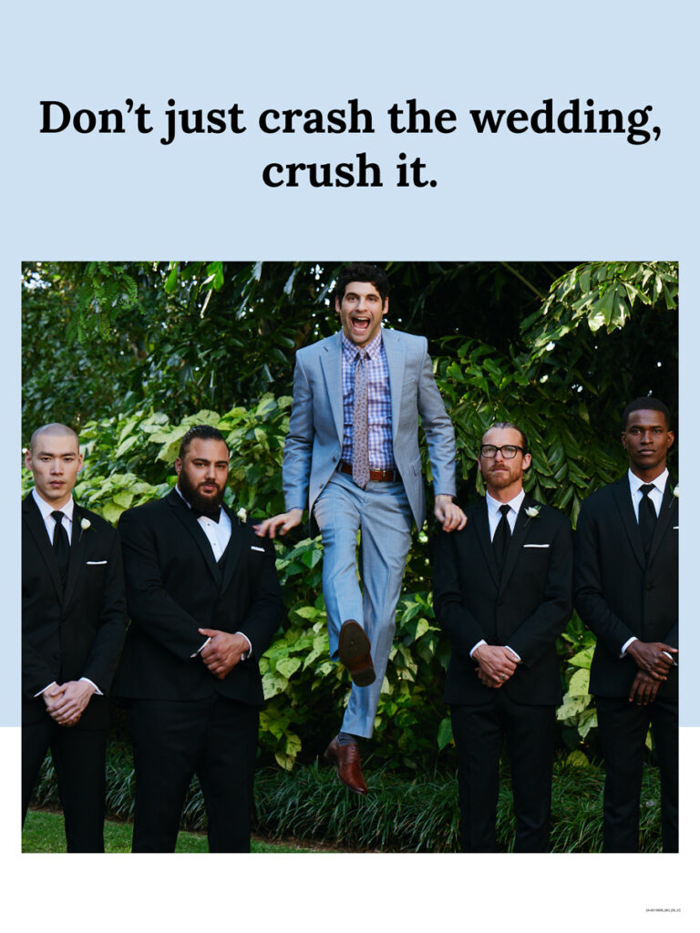 a man in a light blue suit jumping above four groomsmen in black suits