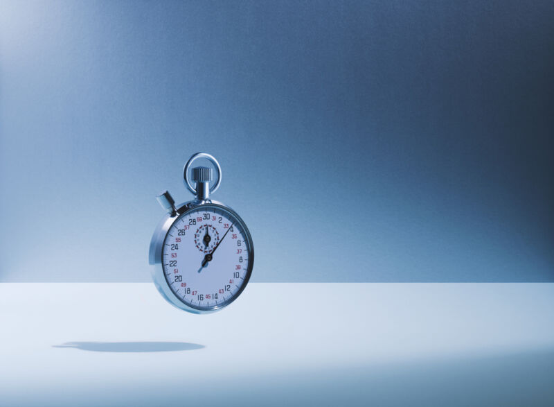 Image of a stopwatch against a blue-grey background.