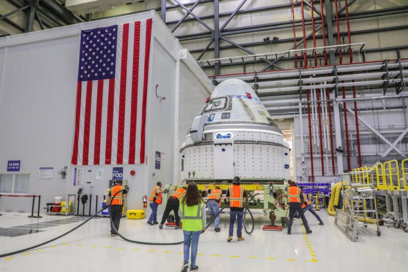 Technicians at NASA's Kennedy Space Center in Florida prepare Boeing's Starliner spacecraft for fueling.