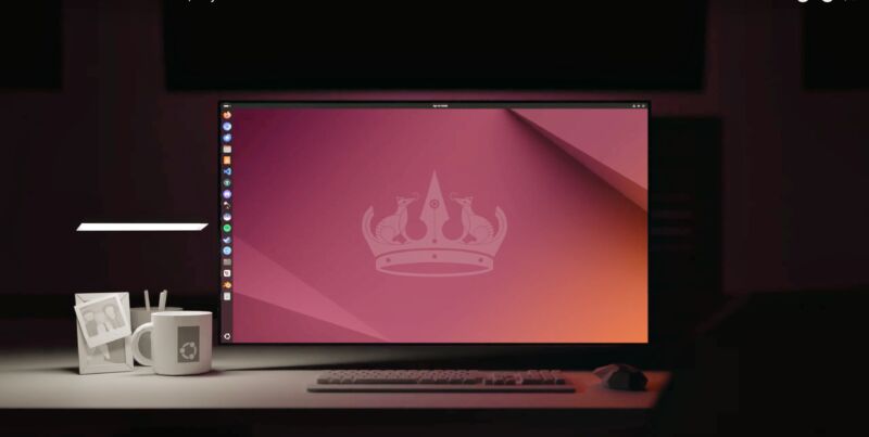 Ubuntu desktop running on a laptop on a 3D-rendered desktop, with white polygonal coffee mug and picture frame nearby.