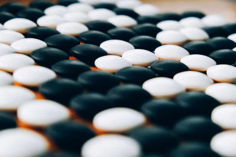 Man vs. machine in a sea of stones.