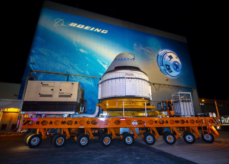 A Starliner spacecraft departs Boeing's spacecraft processing facility before the program's first orbital test flight in 2019.