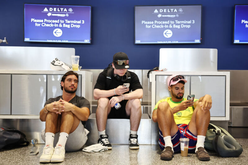 LOS ANGELES, CALIFORNIA - JULY 23: Travelers from France wait on their delayed flight on the check-in floor of the Delta Air Lines terminal at Los Angeles International Airport (LAX) on July 23, 2024 in Los Angeles, California.