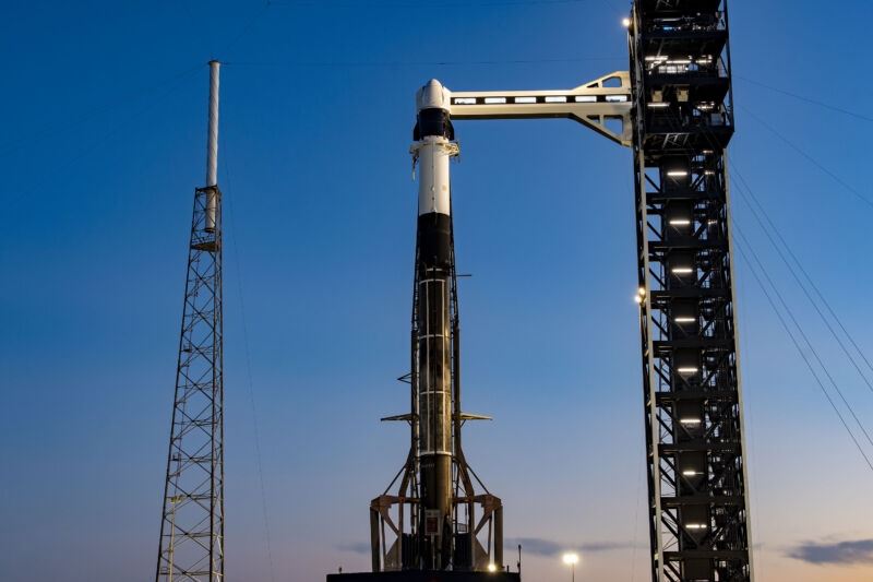 SpaceX's Falcon 9 rocket and Cargo Dragon spacecraft, seen here with the new launch tower and access arm at SLC-40.