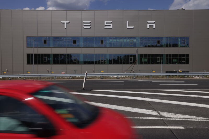 A car drives past the Tesla logo outside the Tesla factory on July 17, 2023 near Gruenheide, Germany.