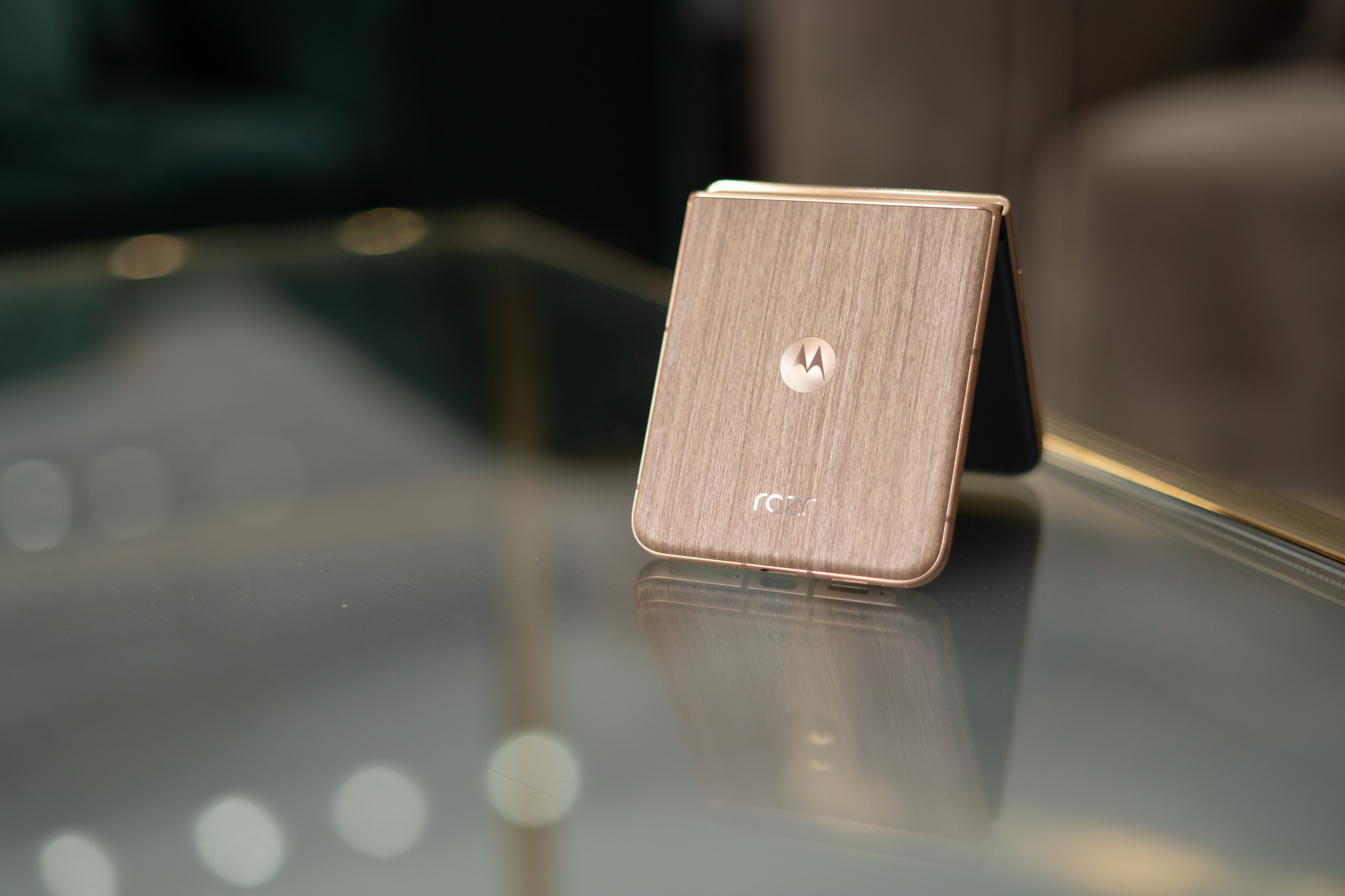 Motorola Razr Ultra 2025 with wood grain back shown on a table.