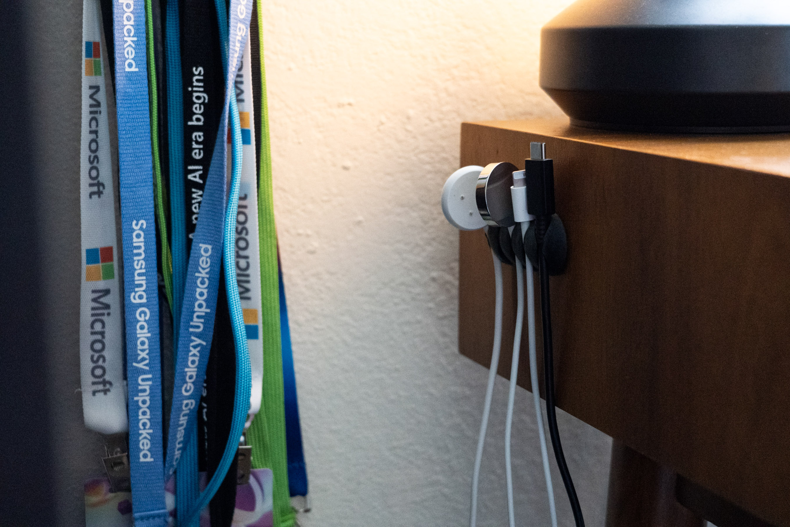 side of desk with several cords hanging from the side