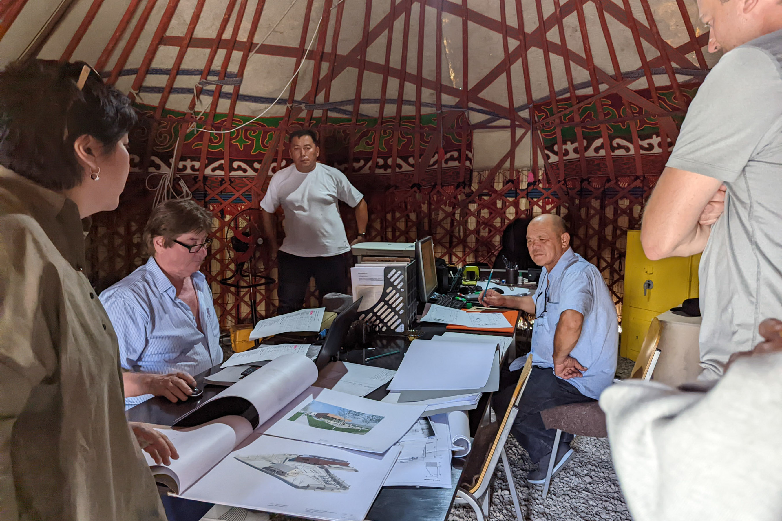 A traditional yurt becomes an office where architects and the Tumar team are discussing plans for the expansion of their sustainable raw wool processing facility, which had been partially funded by USAID.