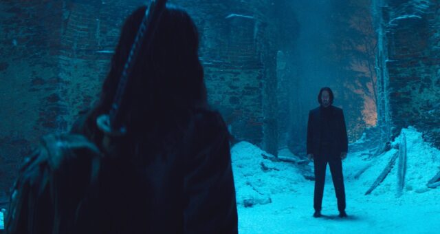 blue-hued snowy scene with menacing man dressed in black to the first, and the back of a young girl to the left.