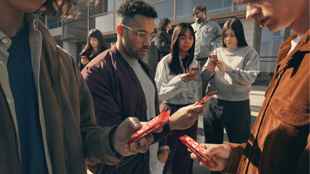 a man holding a KitKat