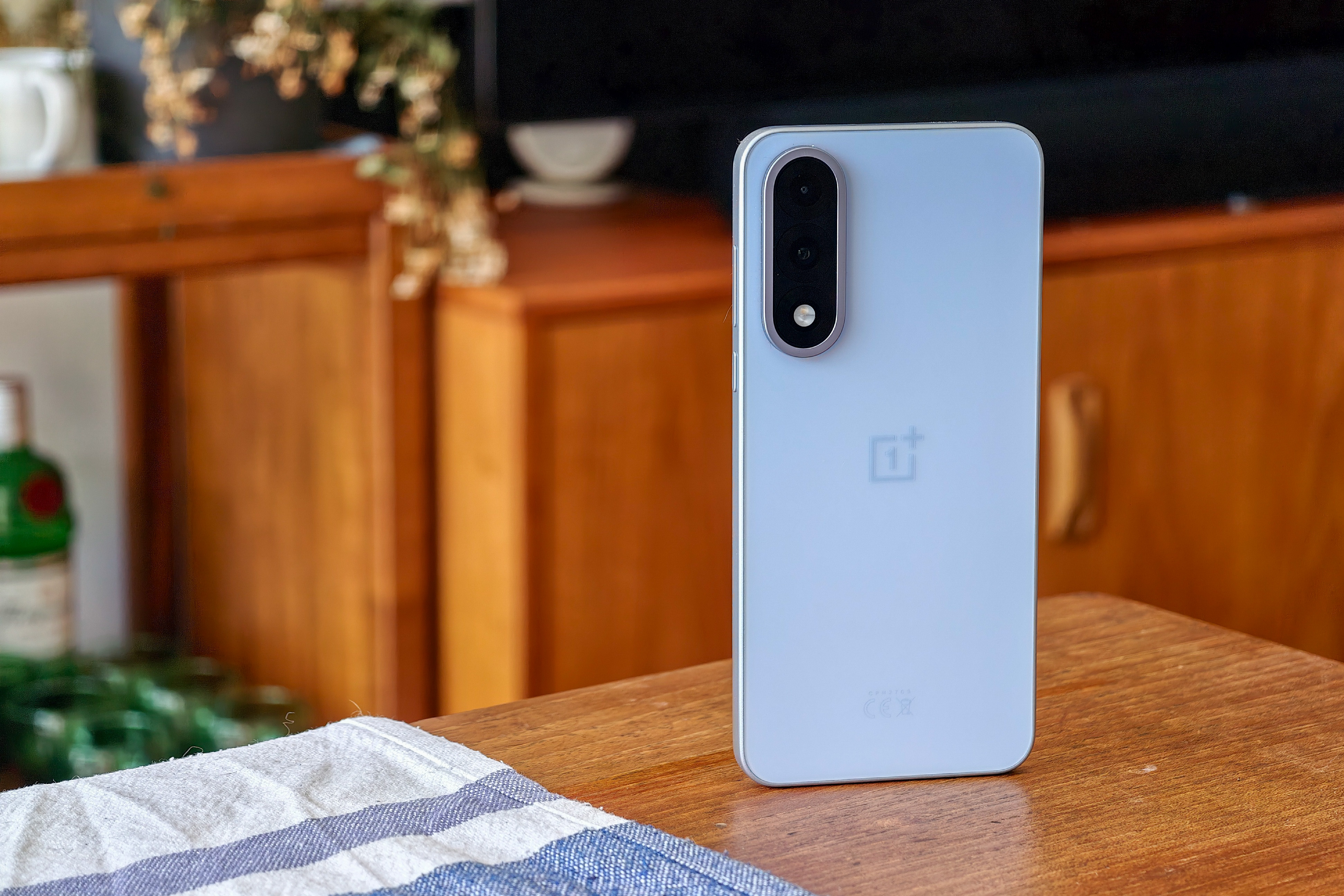 Photo of the OnePlus Nord 5 on a wooden table.
