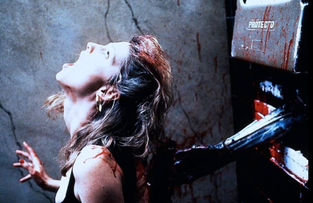 young woman in nightclub wear being impaled on the toilet by a tentacle coming through the stall wall.