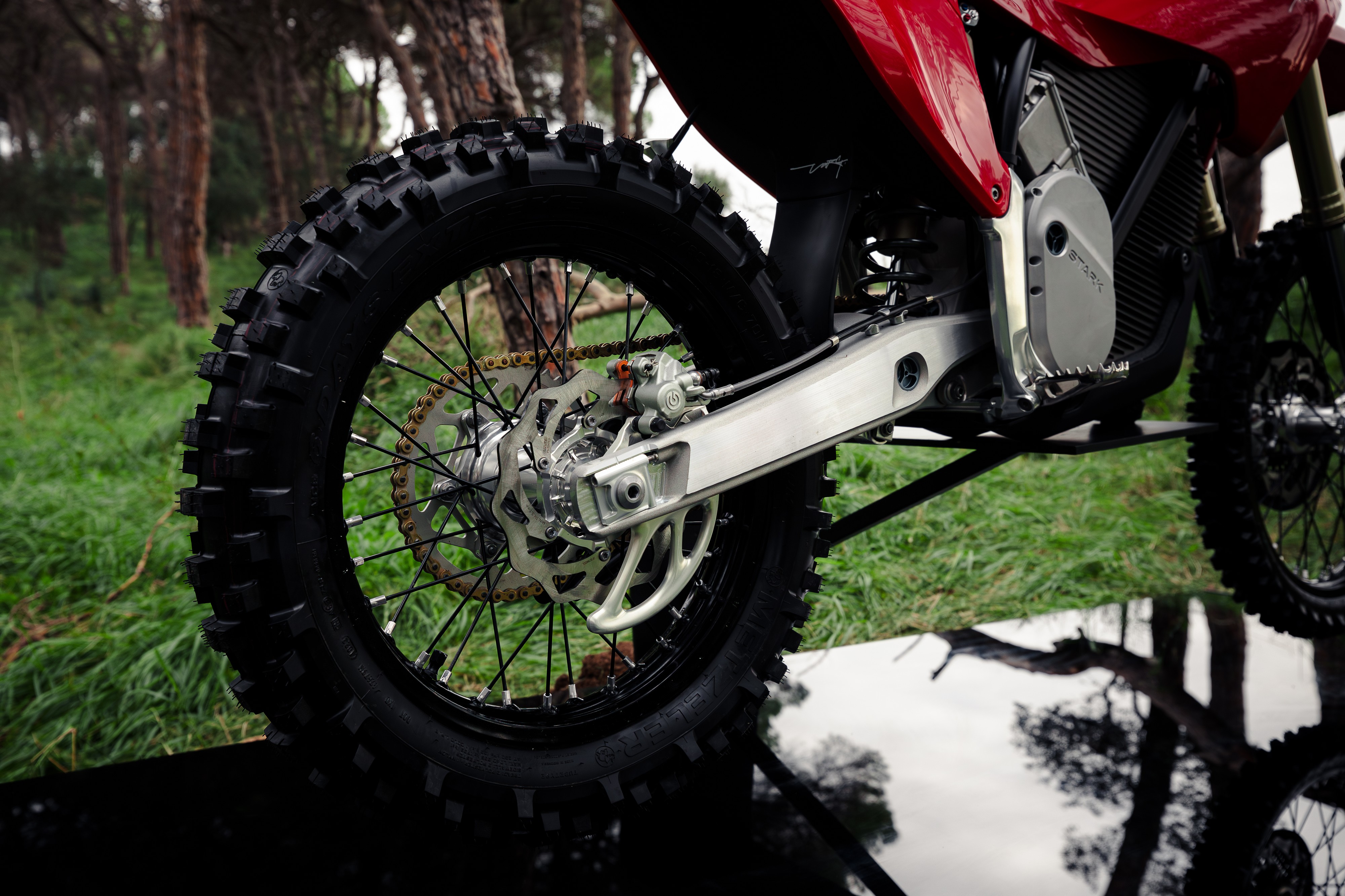 The rear wheel and chain of an electric Stark motorcycle.