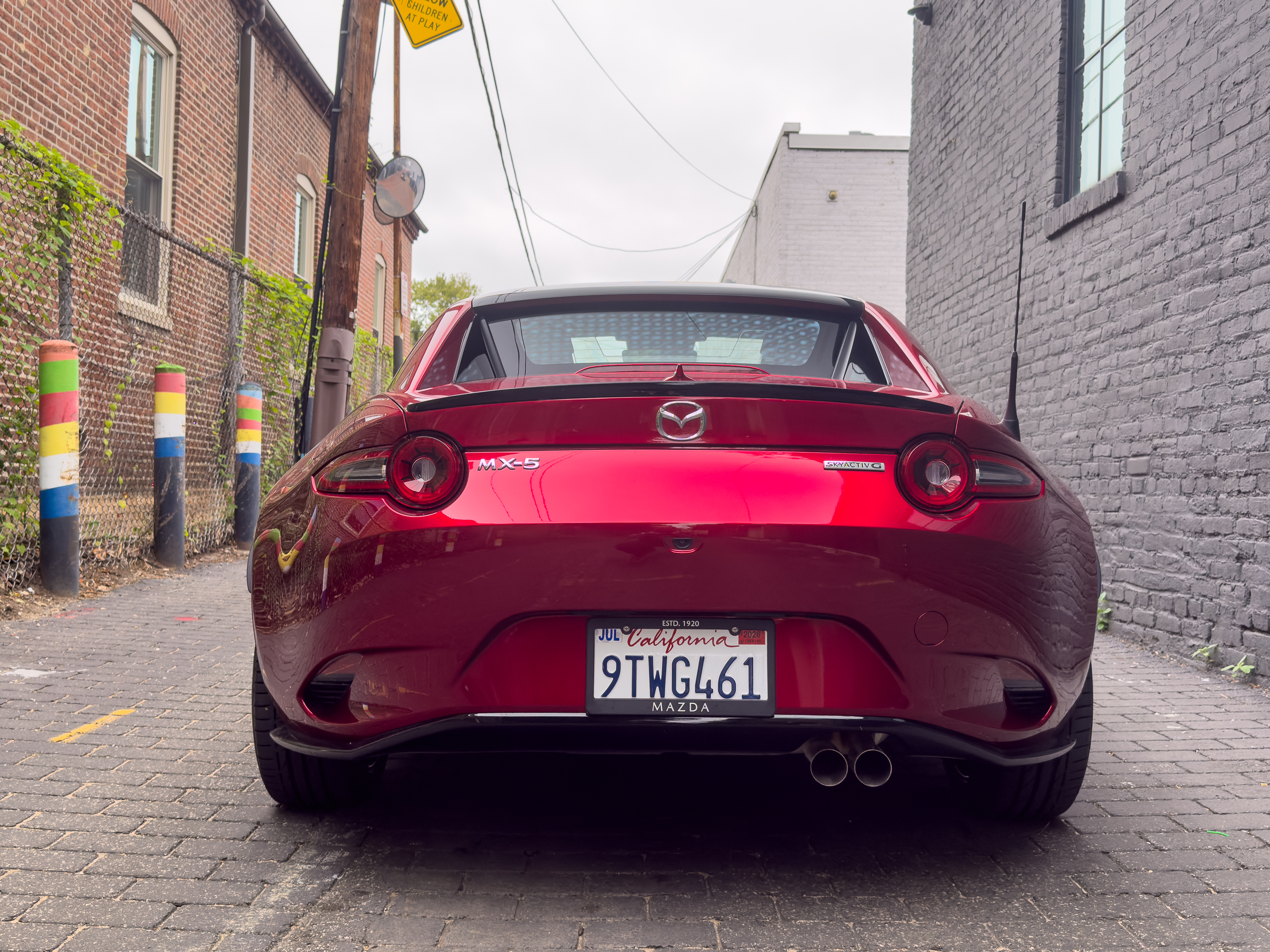 A red Mazda MX-5 Miata RF seen from behind.