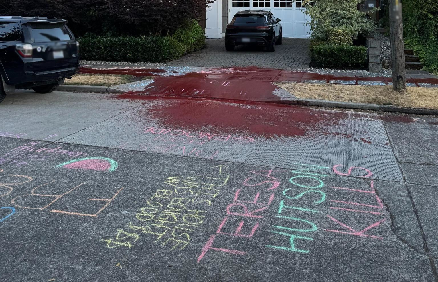 The chalk and red paint outside a Microsoft executive’s home (blurred and cropped to remove identifying details).