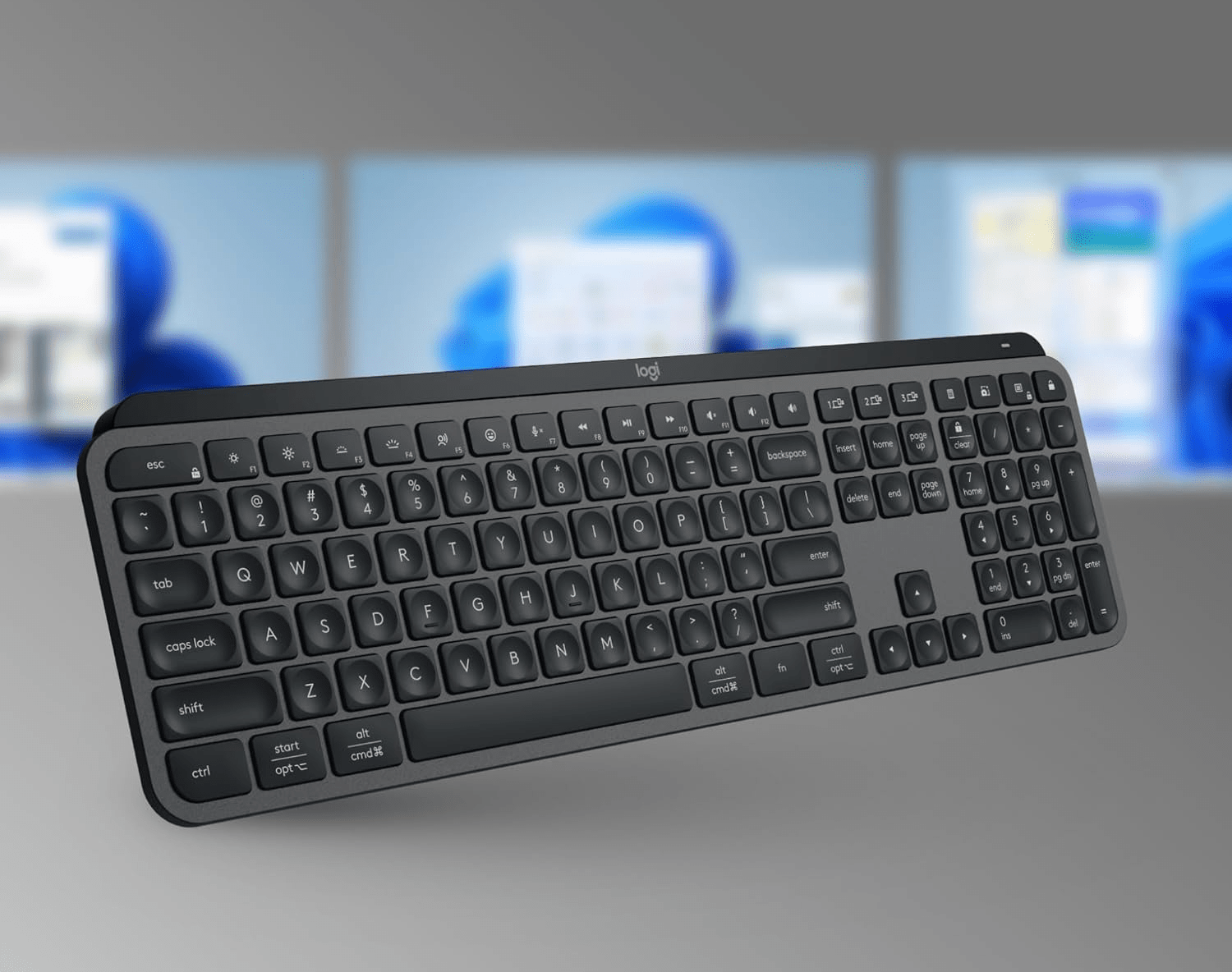 Keyboard in front of three monitors