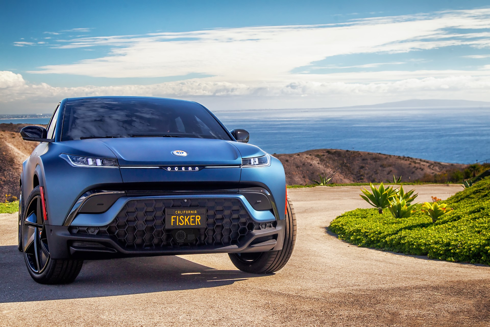 blue fisker ocean suv on a trail