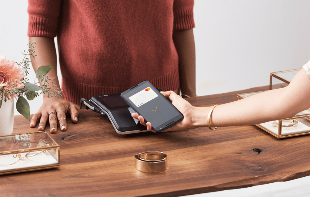 Image of consumer using Mastercard.