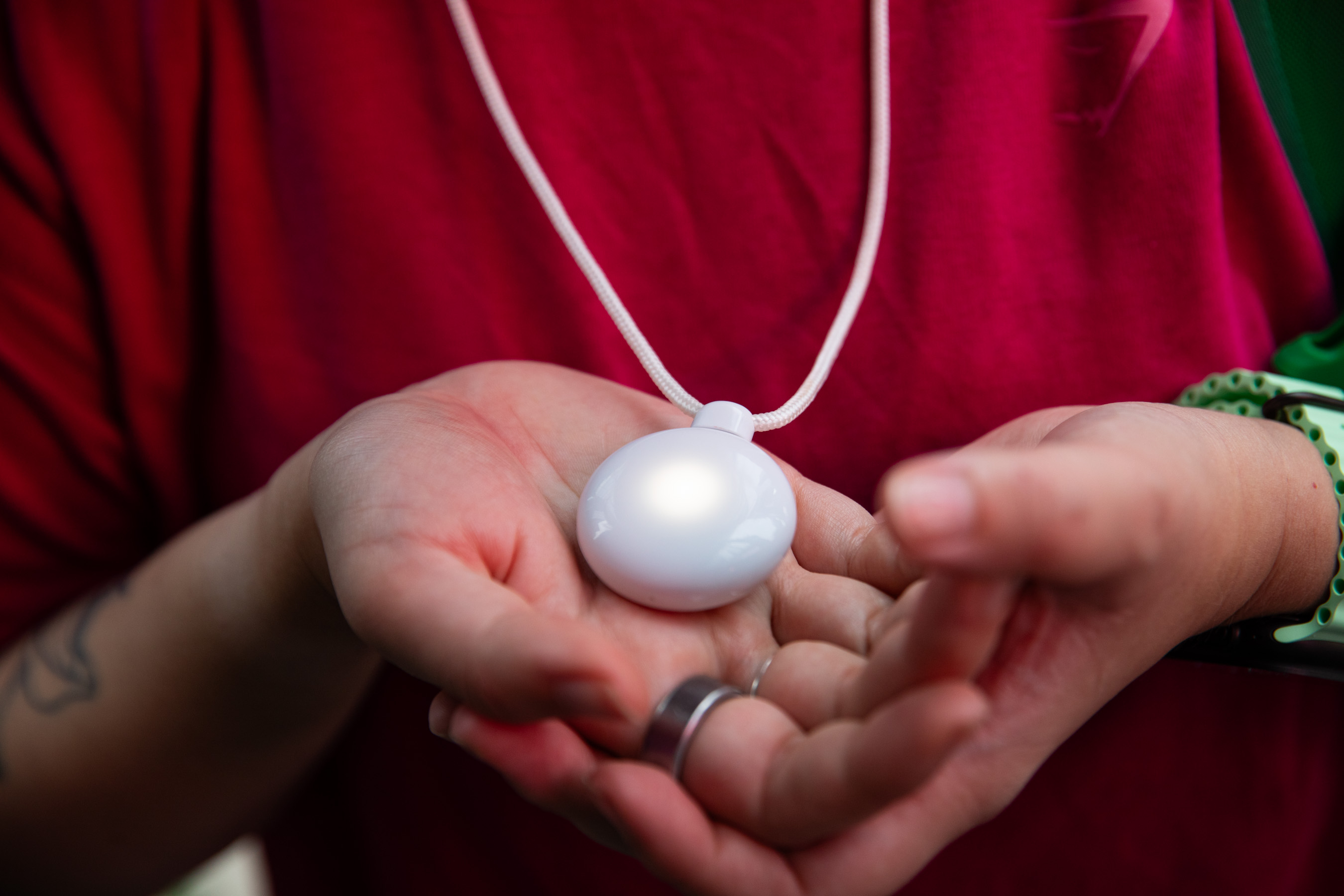 Person holding Friend in their hands while it glows 