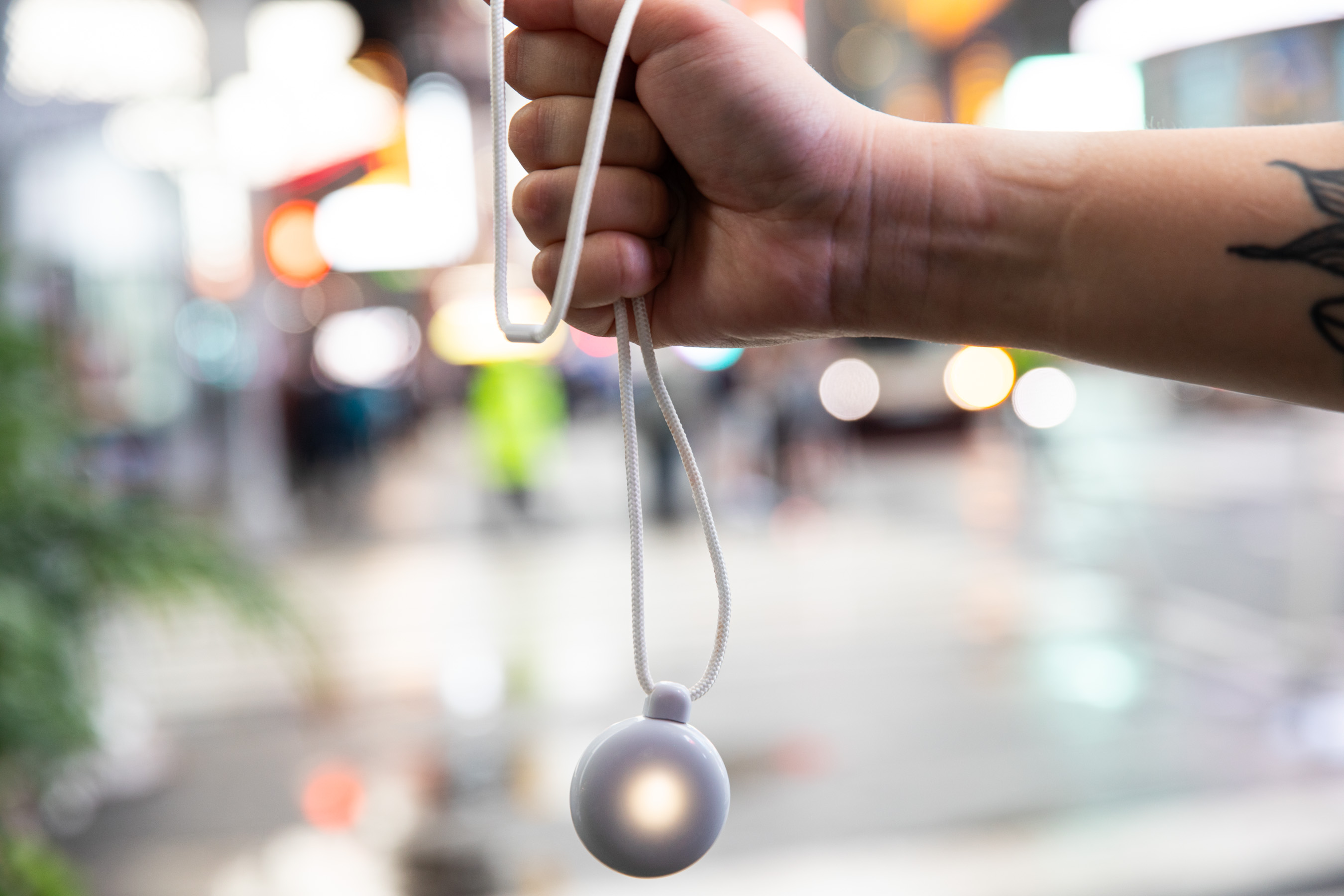 Person holding Friend in an outstretched fist.