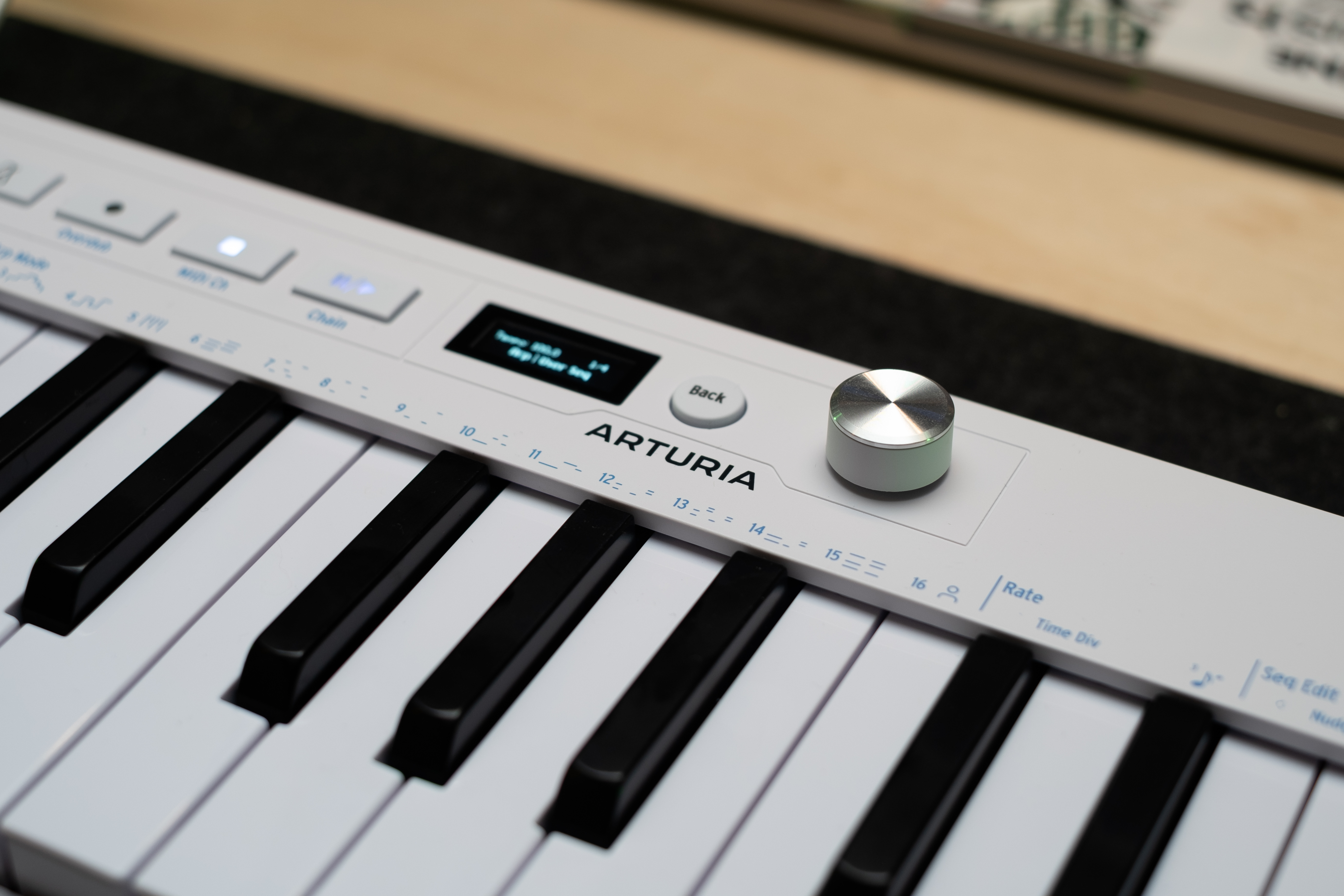 Close up of the Arturia logo alongside the new endless encoder and OLED on the KeyStep mk2.