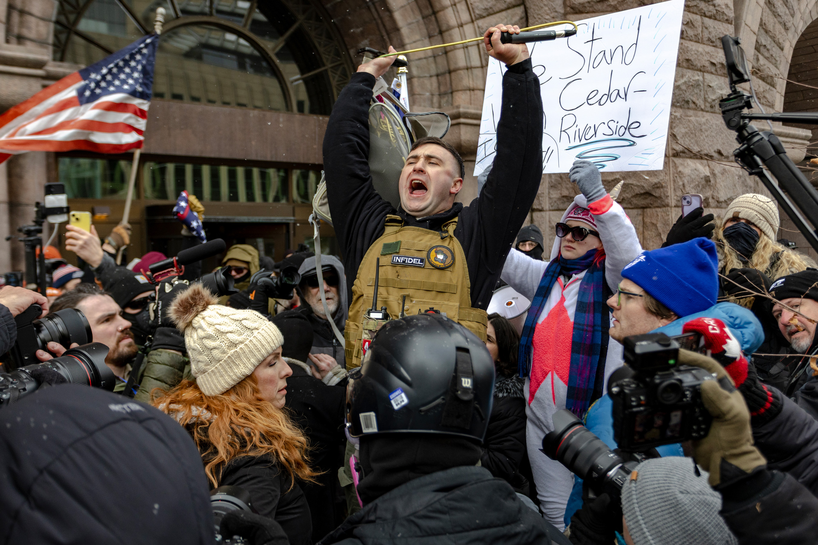 Right wing influencer Jake Lang is confronted by protesters at a rally near city hall.