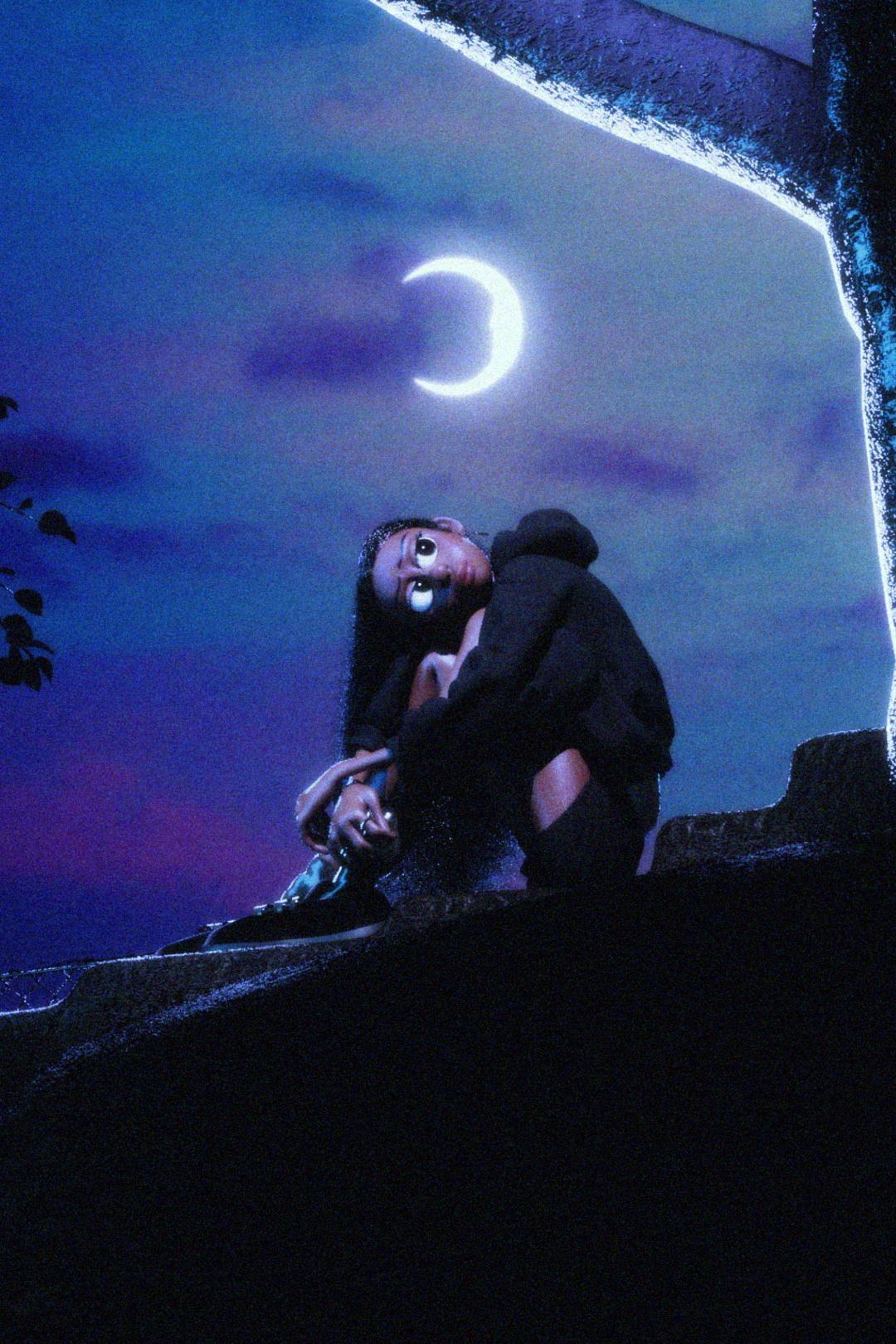 Mary hugging her knees on a cement stoop.