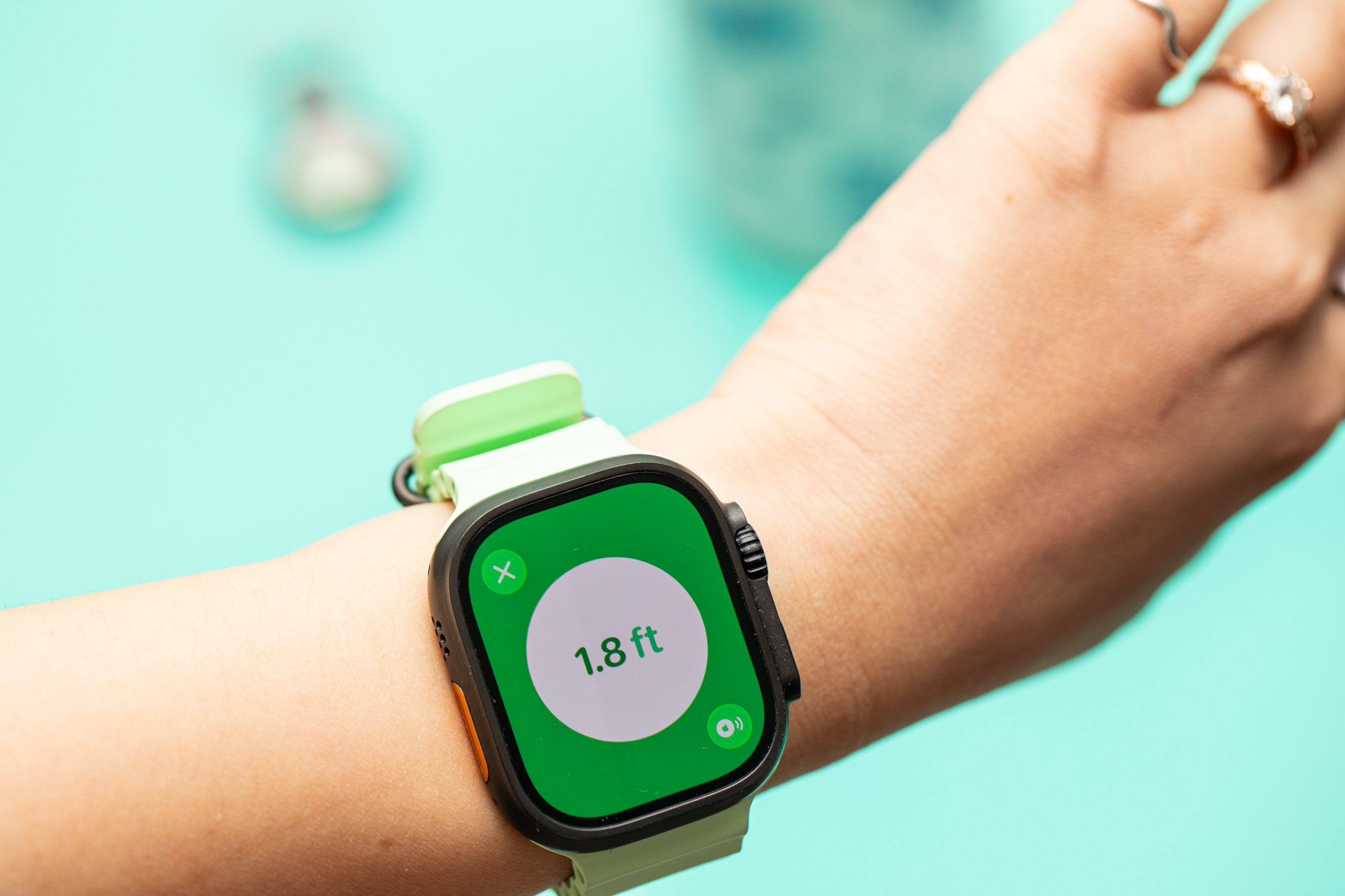Person looking at the Precision Finding feature for an AirTag on the Apple Watch Ultra 2.