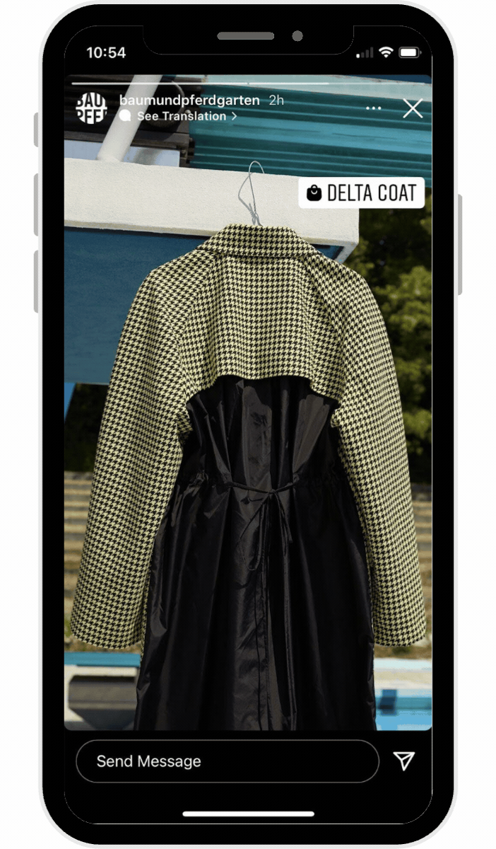 Houndstooth and black coat hanging on a rack, displayed within a smartphone screen showing instagram stories with a product tag and send message option visible.