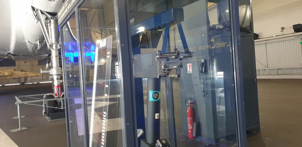 Image of a museum display, showing a scientific instrument behind glass.
